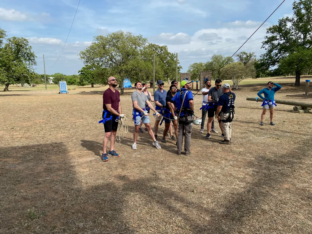 Invisible AI team members holding a rope for tightrope walking